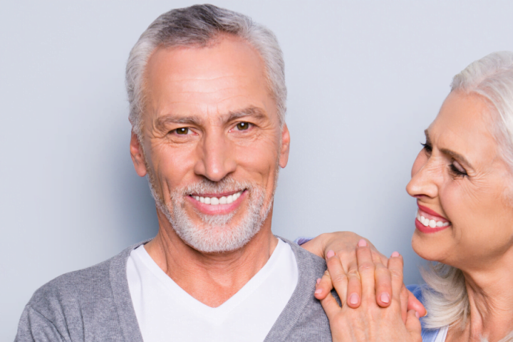 older couple smiling because they love their dental implants